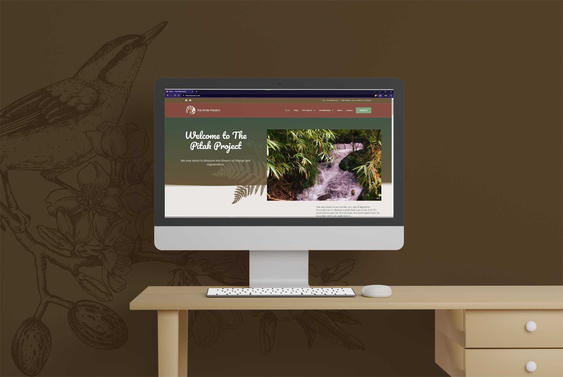 The Pitak Project homepage shown on a desktop monitor mockup, with the welcome hero and its waterfall photo