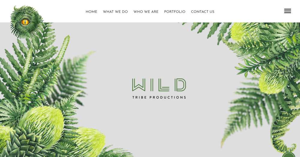 The Wild Tribe Productions homepage with the studio wordmark framed by a botanical illustration of ferns and flowers, and a nav reading Home, What We Do, Who We Are, Portfolio, and Contact Us
